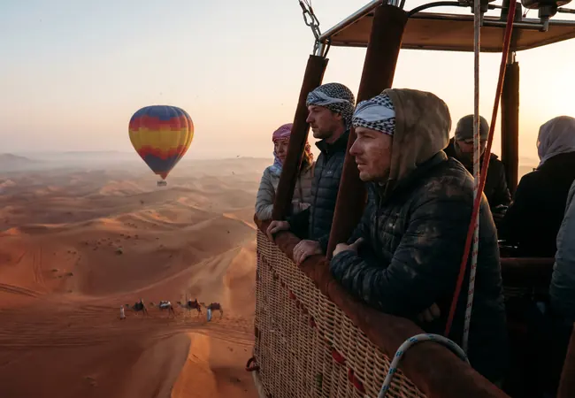 Hot air balloon rising over the Dubai desert at sunrise